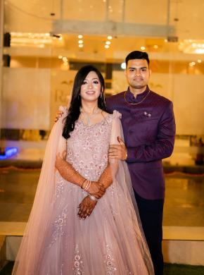 Couple posing indoors in elegant outfits during reception photography