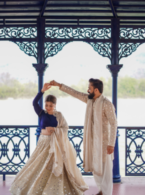 Bride and groom posing near gazebo during outdoor pre wedding shoot
