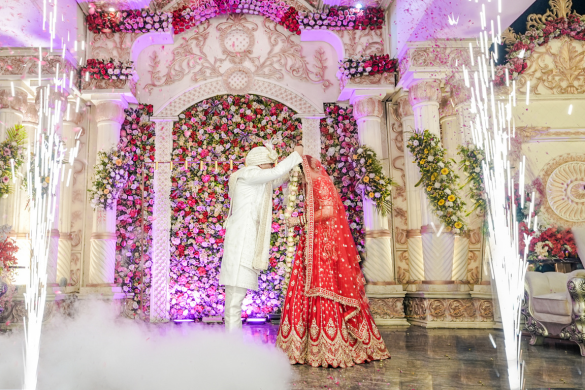 Bride walking through floral-lit entrance decor during wedding ceremony