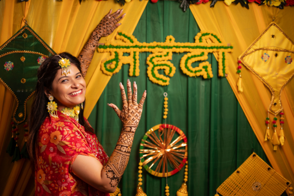 Mehndi event stage decorated with yellow floral theme and traditional elements