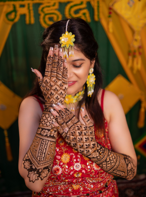 Bride showing intricate mehndi during pre wedding celebration