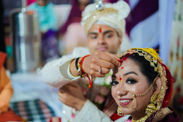 Groom receiving tilak during traditional Indian wedding ritual