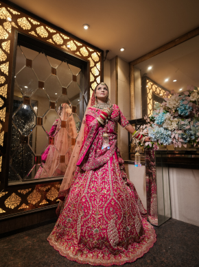 Bride posing in mirror while getting ready in bridal room