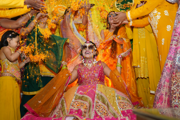 Bride dancing joyfully during vibrant haldi ceremony