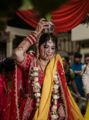 Bride performing cultural wedding ritual decorated with flowers